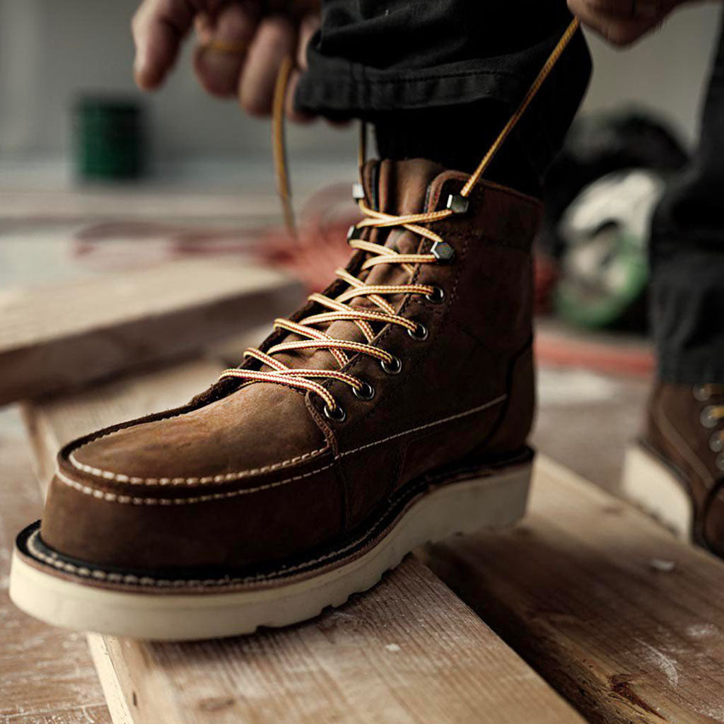 Brown QLTY work boots on lumber