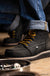 DNVR work boots in brown on the job site.